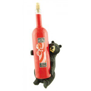 A bear hugging a wine bottle