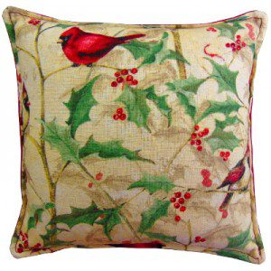 A pillow with a cardinal on holly plant
