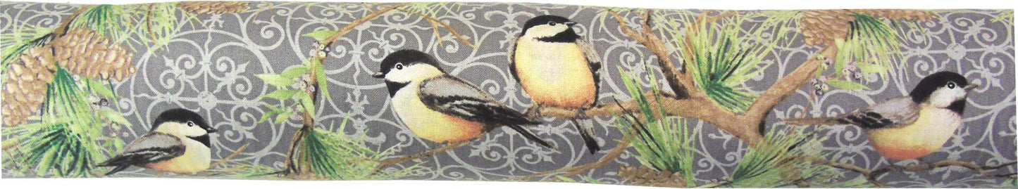 A pillow with chickadees on pine branches print