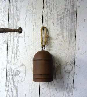 A cow bell ornament