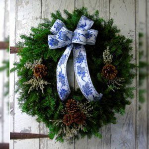 A wreath with a blue and white ribbon
