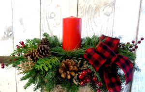 A huge red candle on a wreath