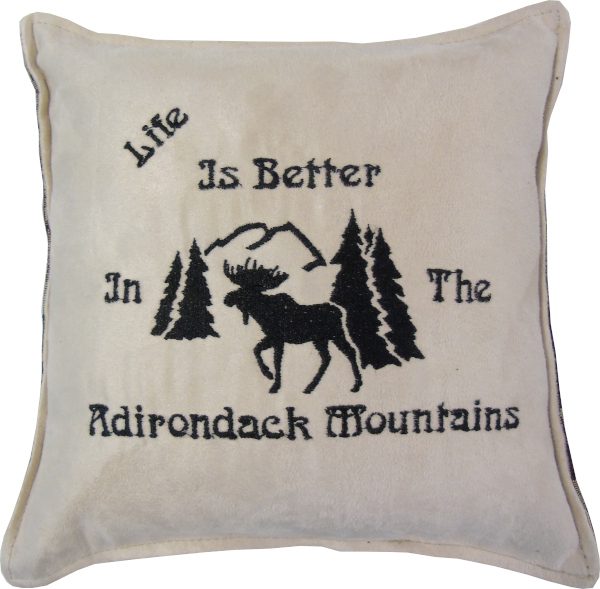 White pillow with a moose and tree design and text “Life is Better in the Adirondack Mountains”