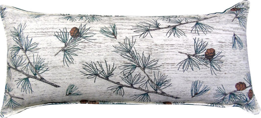 Pine branches on white couch pillow