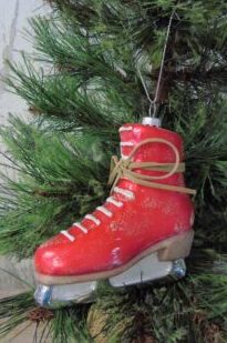 A red skate shoes ornament hanging on a tree